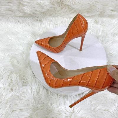 Serpentine-patterned pointed stiletto heels with a low-cut design for a chic and bold look.