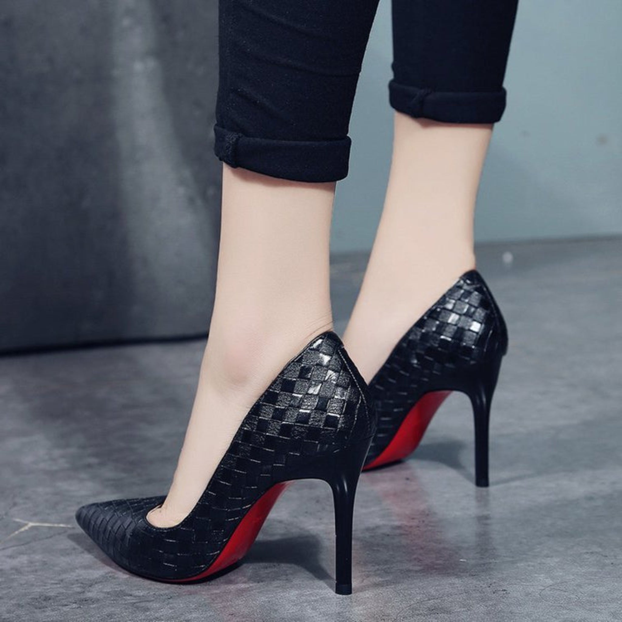 Elegant pointed high heels with a bold red bottom design. 